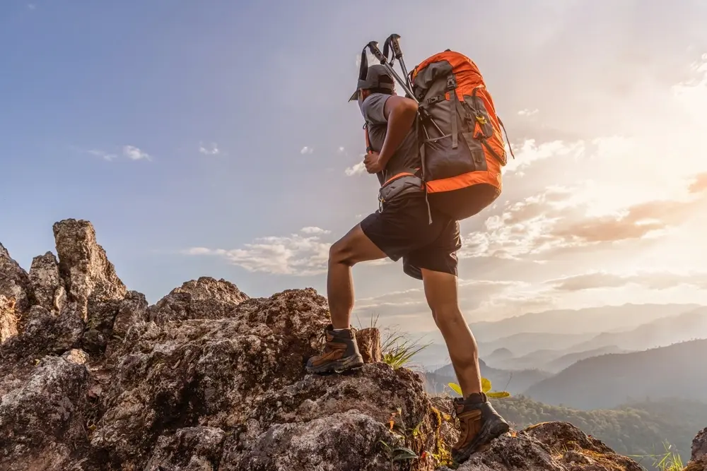 Man hiking on mountain wearing backpack